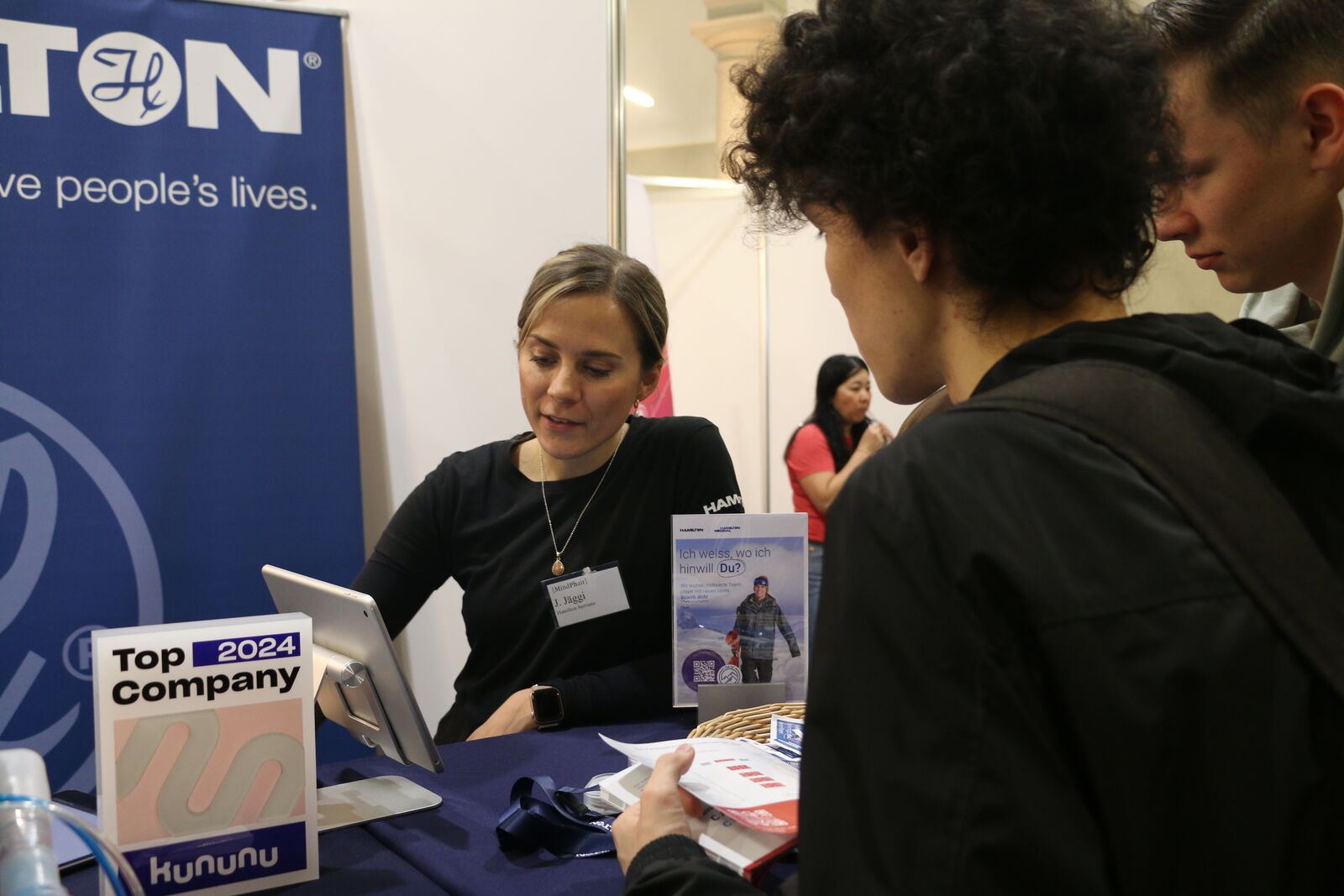 A student reading company material at a booth